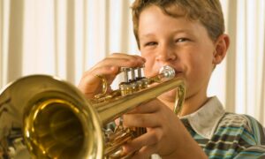 young student playing trumpet obtained through band instrument rental