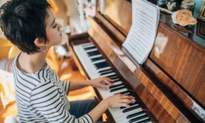 woman practicing after choosing to buy a piano